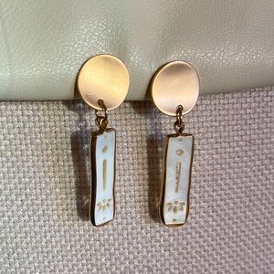 Golden and white handcrafted drop earrings.